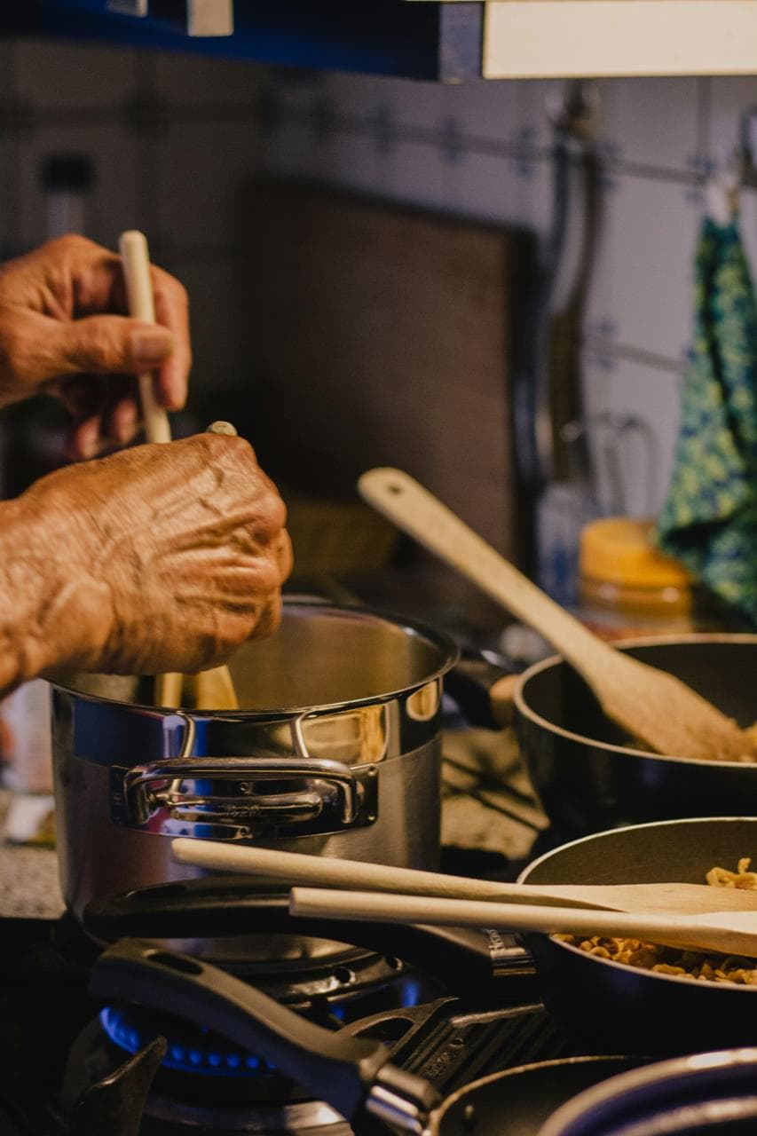Hands cooking on the stove